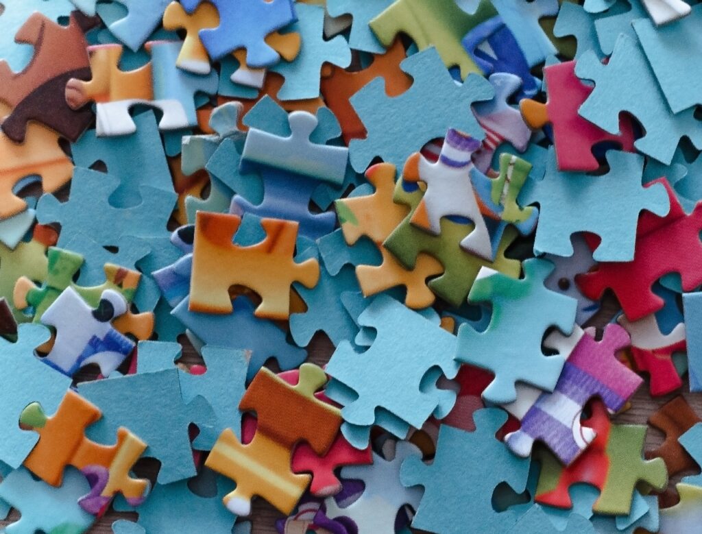 Puzzle pieces stacked waiting for patrons to put puzzle together every Thursday night